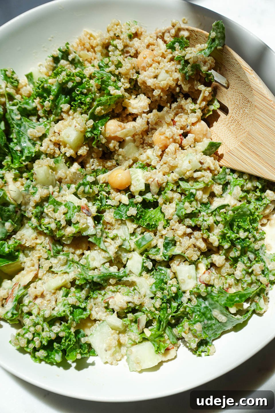Quick Plant-Based Chickpea Quinoa Bowl 7 Close-up of healthy quinoa salad with chickpeas, kale, cucumber, and almonds, beautifully plated
