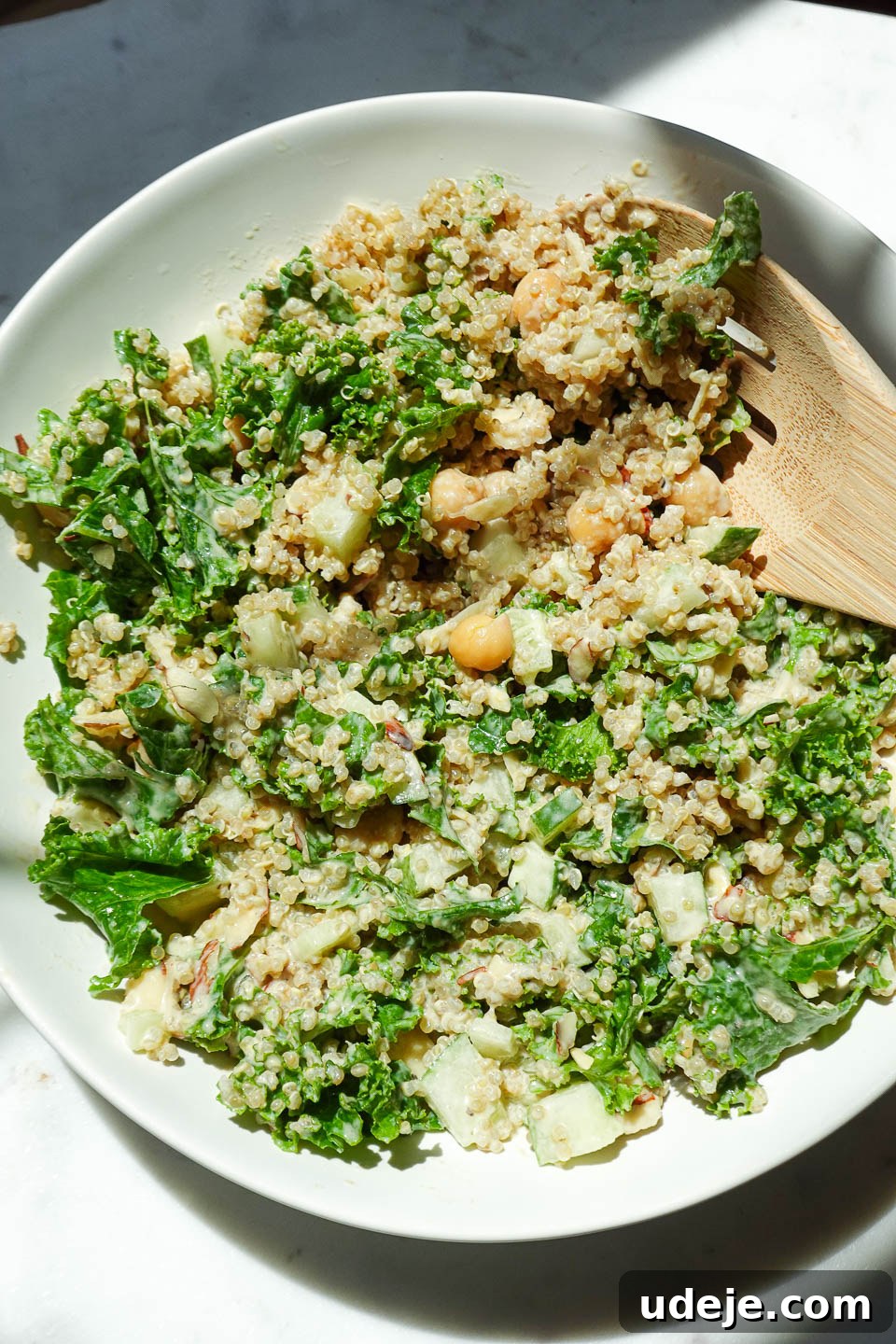 Quick Plant-Based Chickpea Quinoa Bowl 8 Flat lay view of a healthy vegan salad featuring kale, quinoa, chickpeas, almonds, and a drizzle of tahini dressing