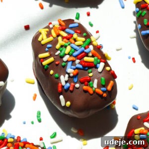 Stardust Brownie Dates 7 Cosmic brownie stuffed medjool dates with rainbow sprinkles on a white plate, ready to be served.