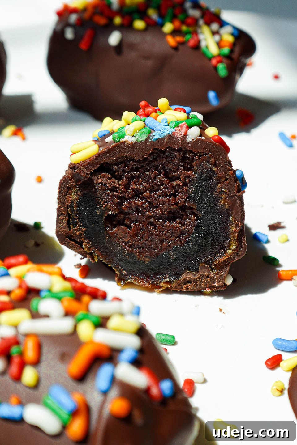 Stardust Brownie Dates 3 Close-up of healthy cosmic brownie stuffed dates with a rich, fudgy brownie filling and colorful rainbow sprinkles, demonstrating their delicious texture.