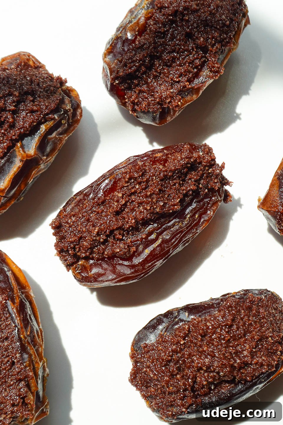 Stardust Brownie Dates 4 Medjool dates stuffed with edible brownie batter, captured before being dipped in chocolate, showing the rich filling.