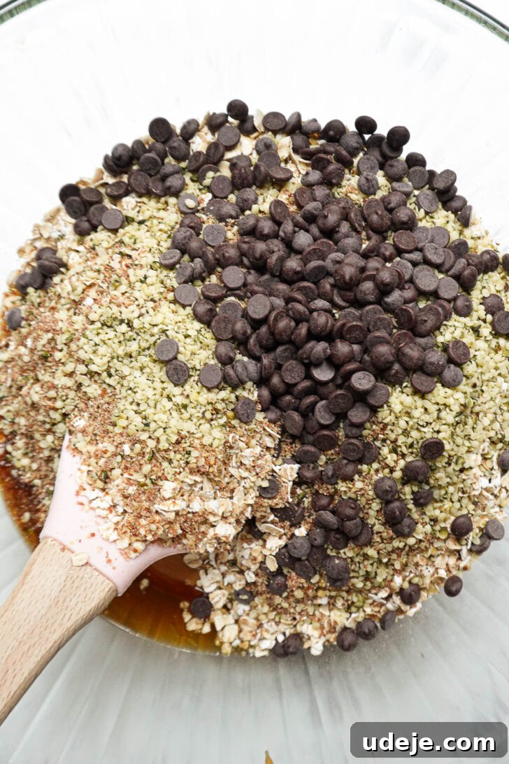 Nourishing Plant-Based Gluten-Free Granola Bars 3 Mixing creamy peanut butter, golden maple syrup, and aromatic vanilla extract in a clear glass bowl