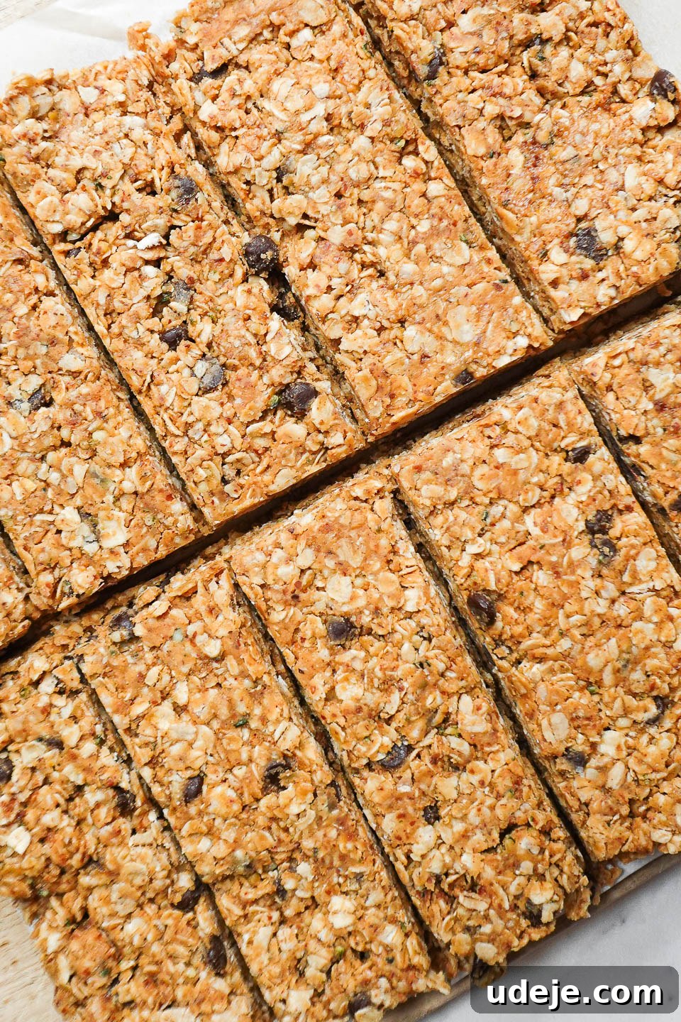 Nourishing Plant-Based Gluten-Free Granola Bars 7 No-bake healthy granola bars cut into neat squares on parchment paper, showcasing their delicious texture