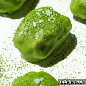 Close up of chewy medjool dates filled with vegan yogurt and dipped in matcha white chocolate