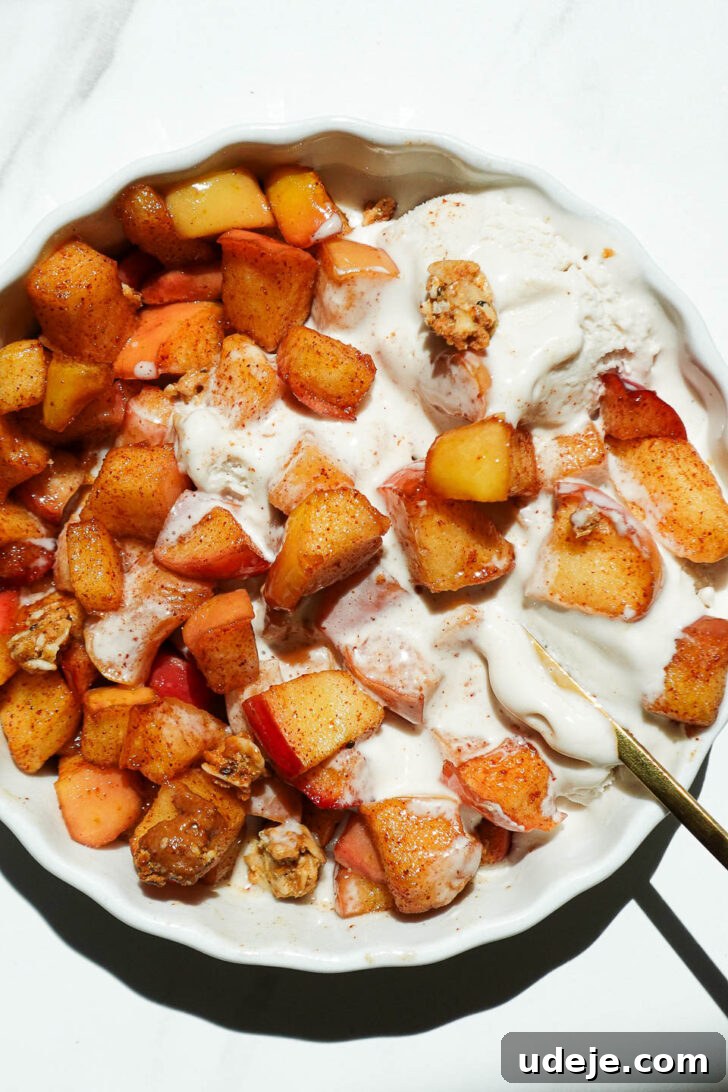 Air Fried Cinnamon Apples 4 Healthy air fryer apples in a ramekin with melty vanilla ice cream and granola on top