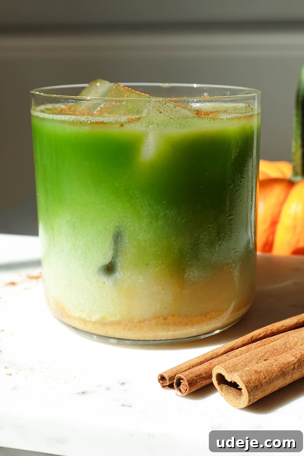 Spiced Pumpkin Matcha Dream 2 A refreshing glass of iced pumpkin spice matcha latte, perfectly layered and garnished for fall