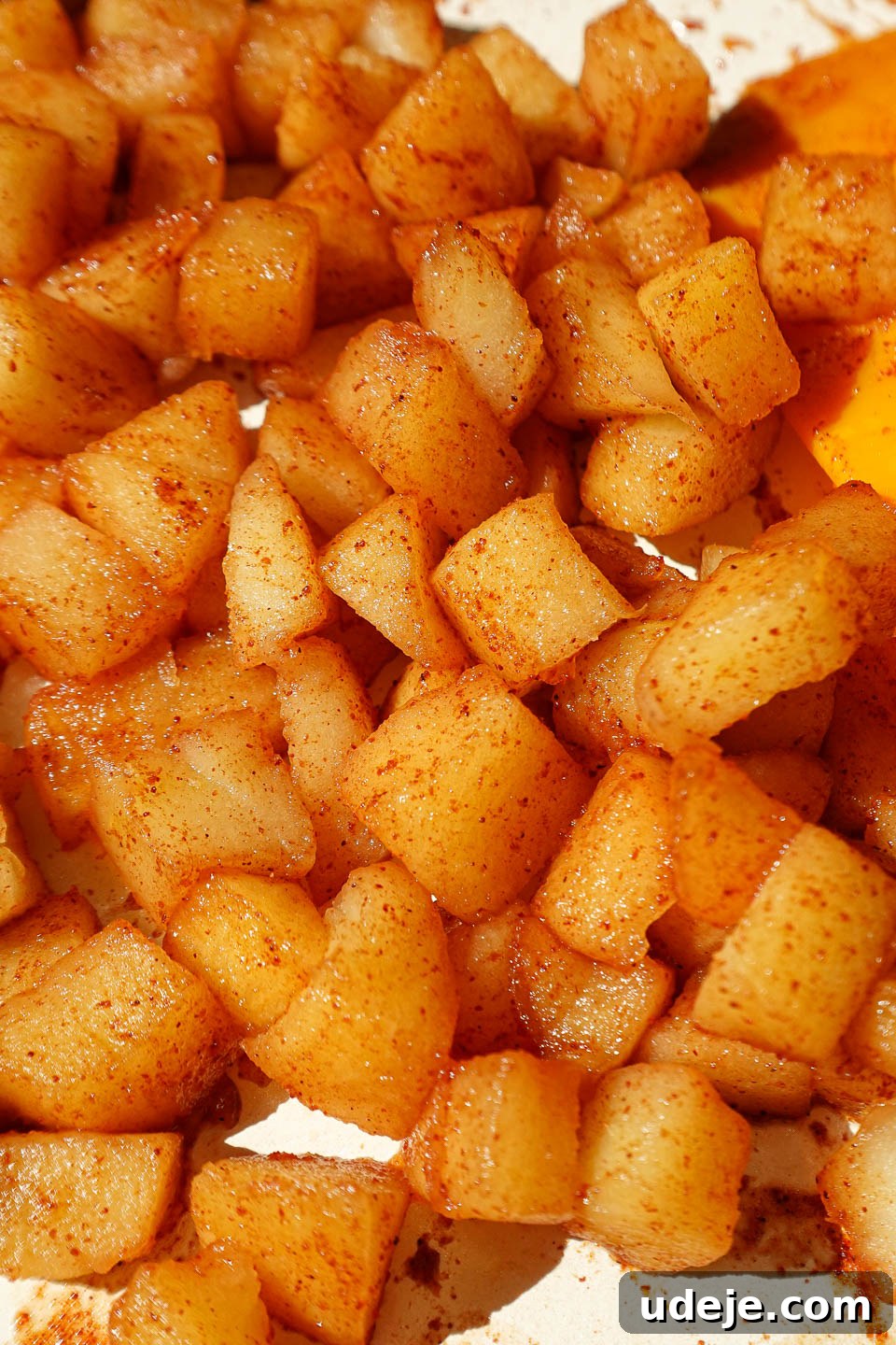 Golden Apple Crisp Date Bites 3 Diced apples sautéing with cinnamon and maple syrup in a skillet, creating a fragrant aroma.