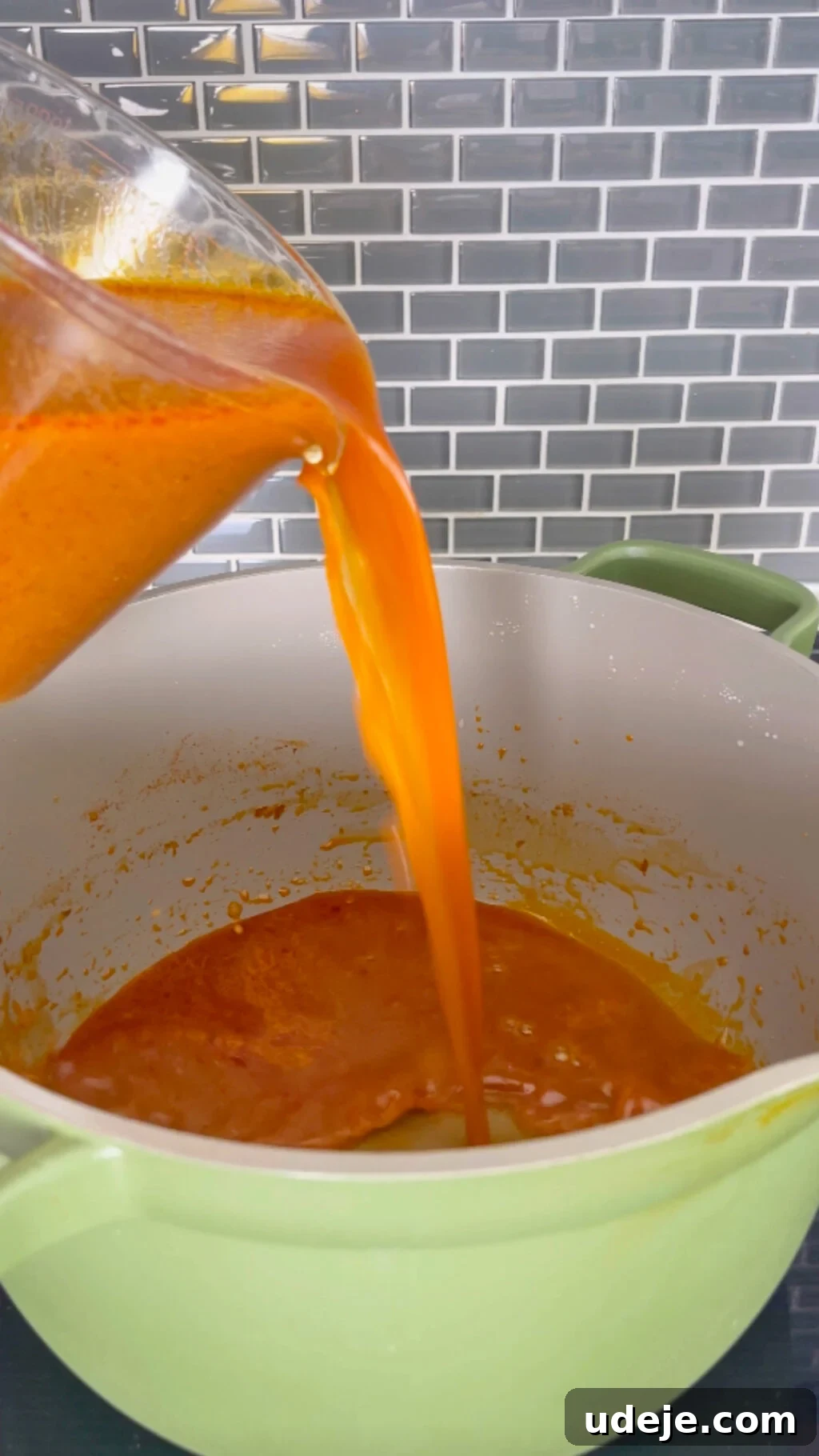 Machboos and Kabsa Aromatic Chicken and Rice 11 tomato broth being poured into a green non stick pot