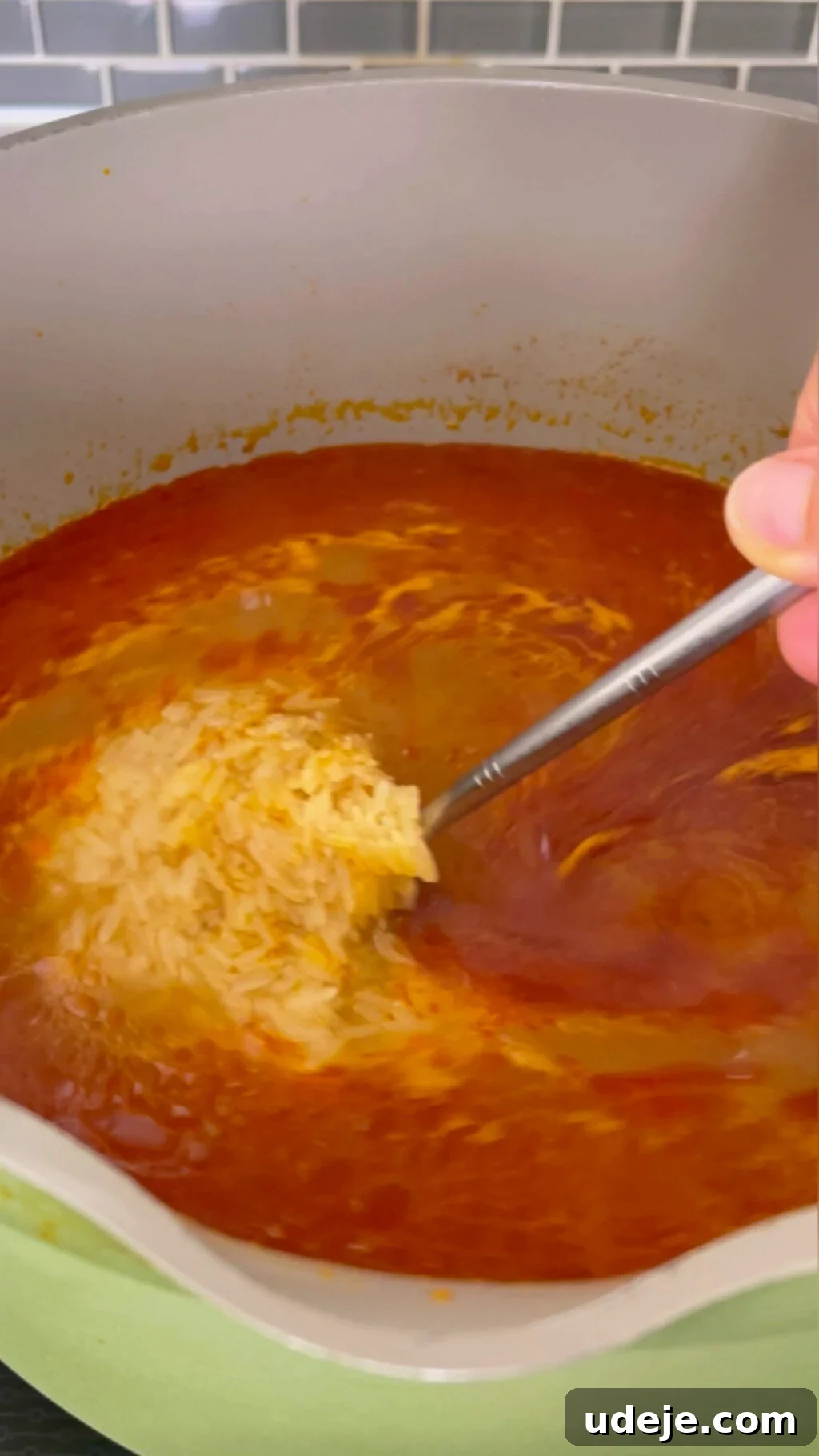 Machboos and Kabsa Aromatic Chicken and Rice 12 tomato broth with uncooked rice inside a large green pot