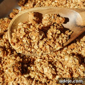 Healthy peanut butter granola with big crunchy clusters on a baking sheet
