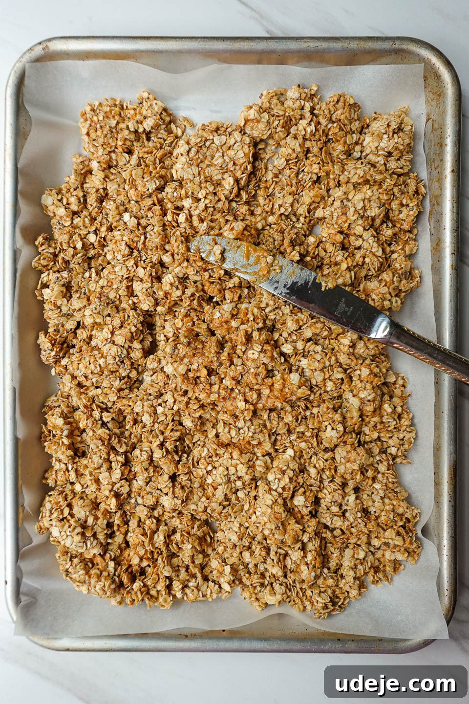 Wholesome Peanut Butter Clusters 4 peanut butter granola on a baking sheet before baking