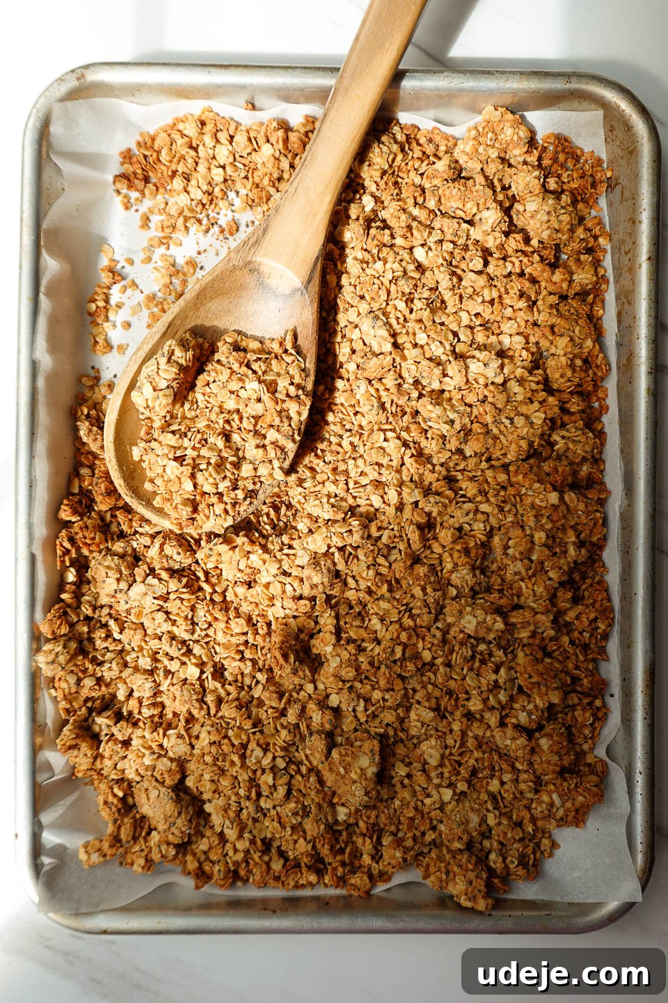 Wholesome Peanut Butter Clusters 5 Homemade peanut butter granola cooling on parchment paper