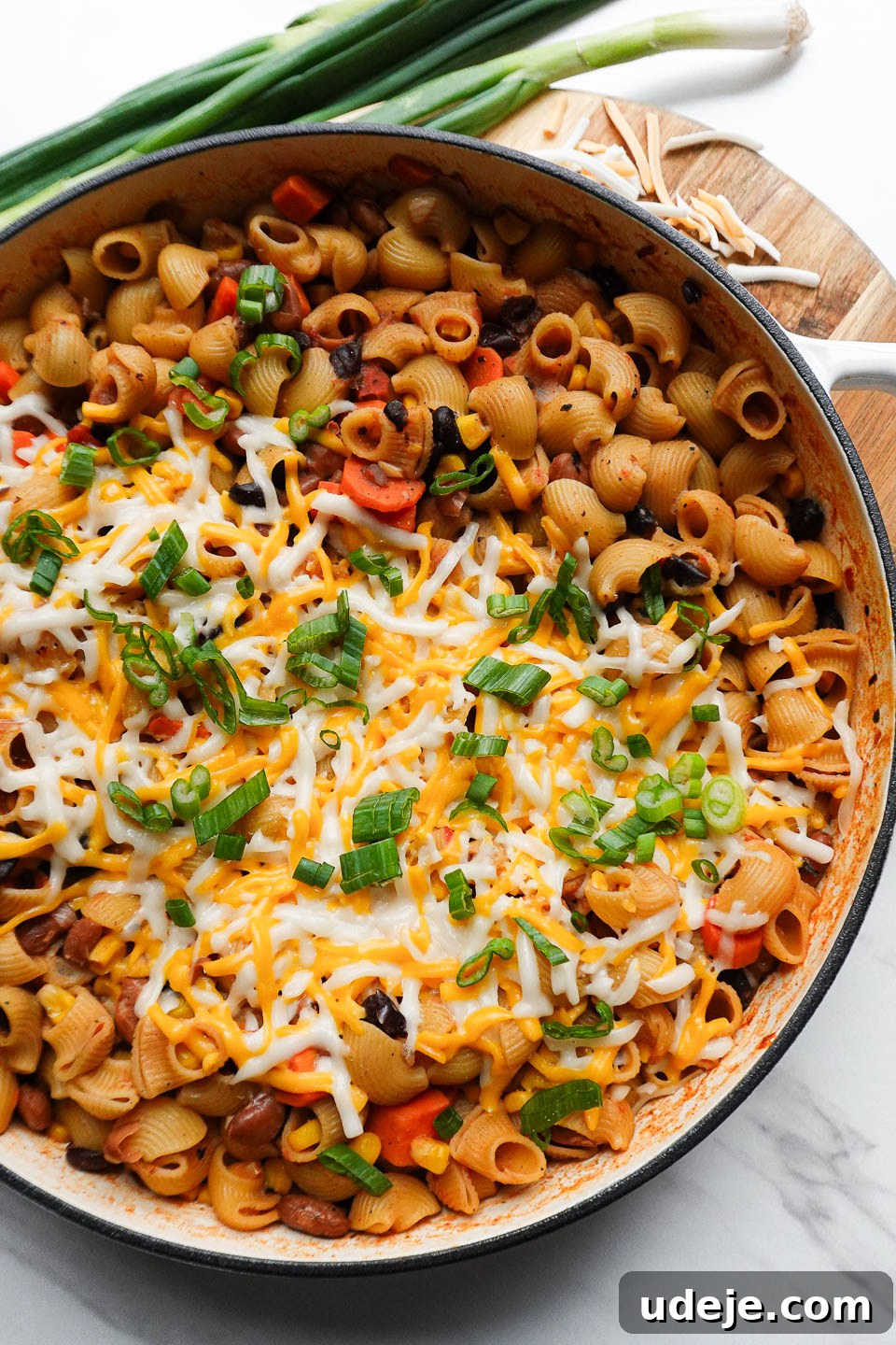 Plant-Based One-Pan Chili Mac and Cheese 2 vegan chili mac and cheese made in one-pot and topped with melted vegan cheese and scallions
