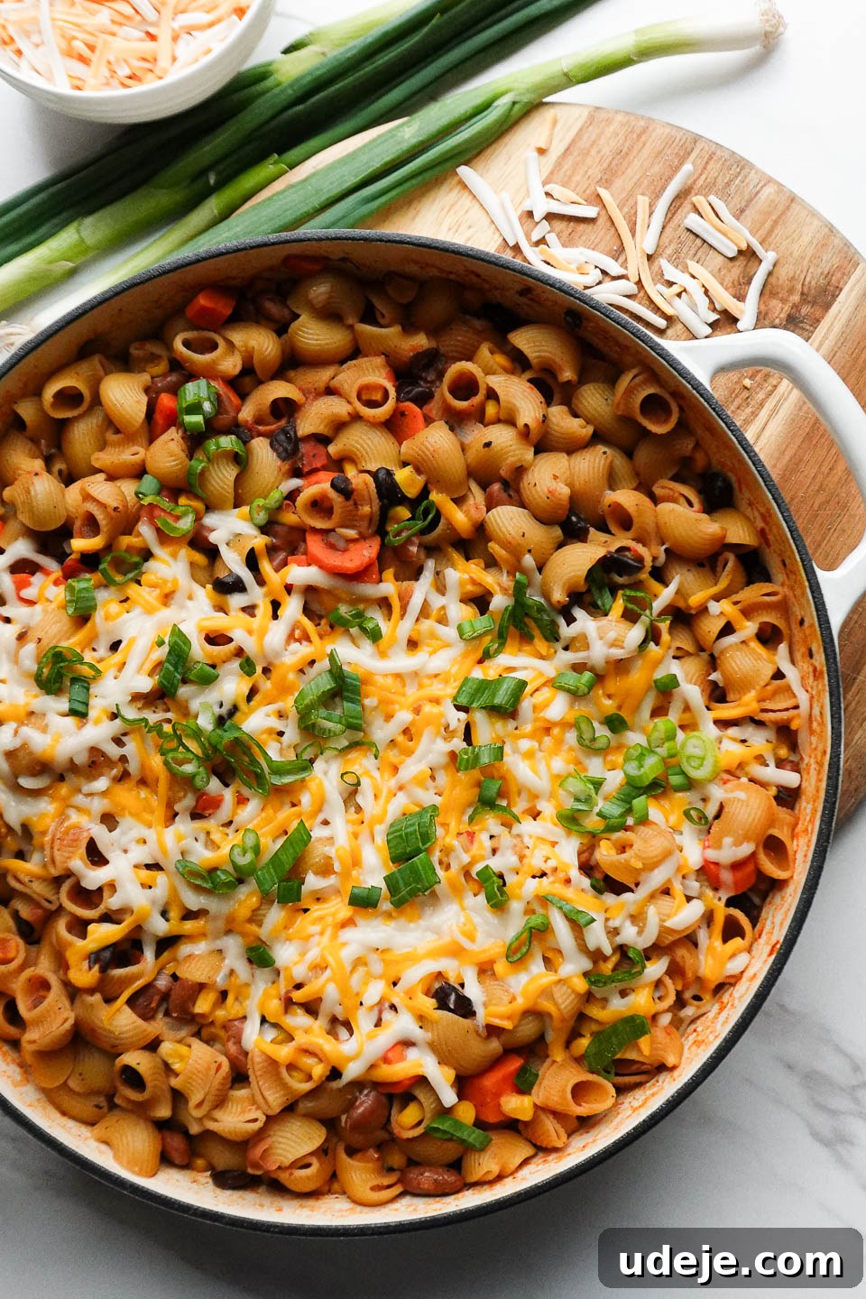 Plant-Based One-Pan Chili Mac and Cheese 6 vegan chili mac and cheese made in one-pot and topped with melted vegan cheese and scallions
