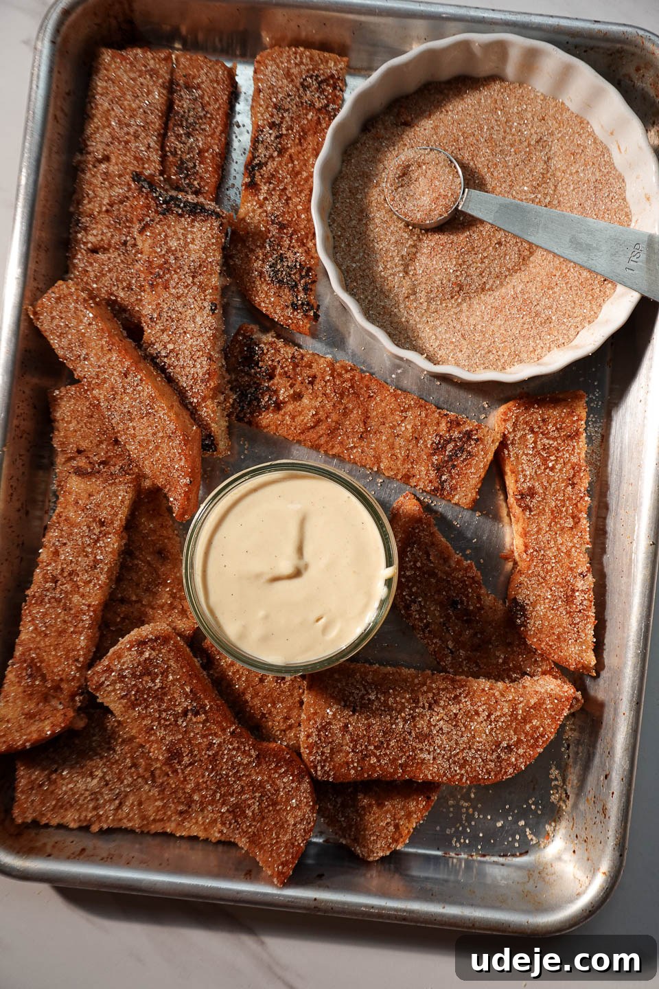 Spiced Vegan Gingerbread French Toast 6 Platter of golden-brown vegan gingerbread French toast sticks artfully arranged with a bowl of creamy yogurt dip