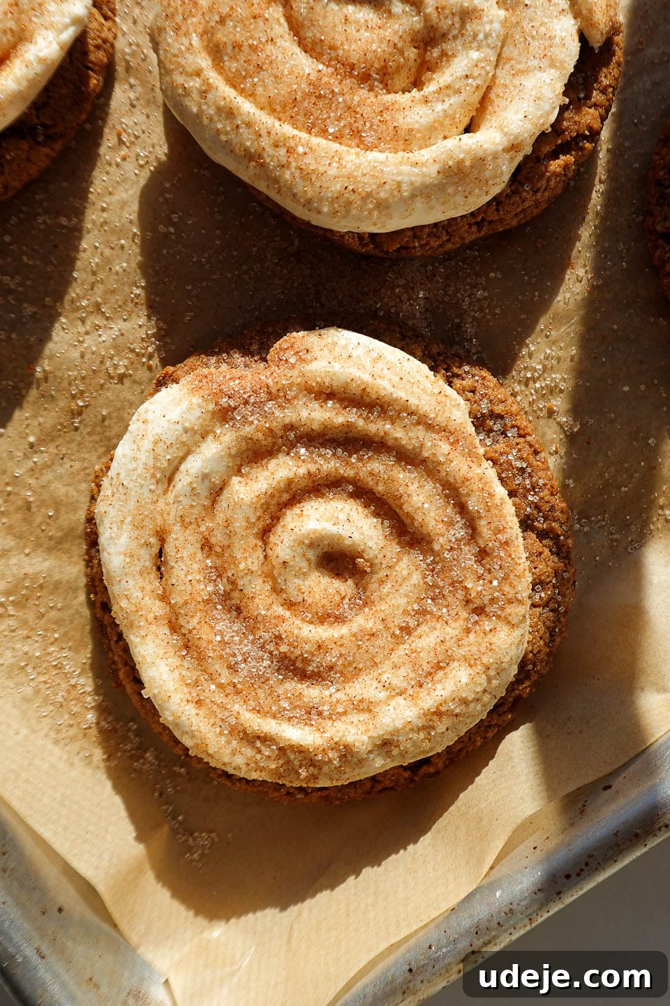 Vegan and gluten-free Crumbl churro cookies topped with creamy swirls and cinnamon sugar
