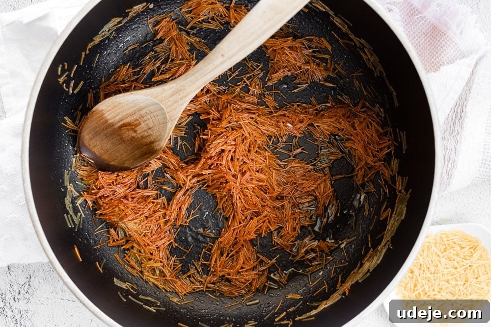 Middle Eastern Golden Vermicelli Rice 3 Golden vermicelli noodles being toasted in a pot with vegetable oil.