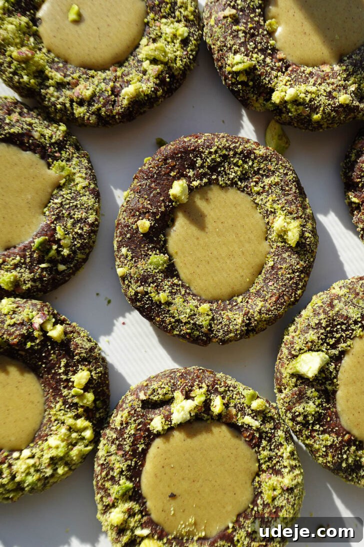 Effortless Vegan Gluten Free Pistachio Thumbprint Treats 5 No-bake pistachio thumbprint cookies rolled in crushed pistachios and filled with pistachio butter