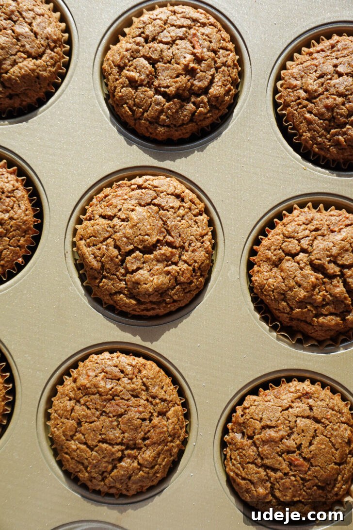 Wholesome Vegan Gluten Free Carrot Cake Muffins 8 freshly baked carrot cake muffins in muffin tin