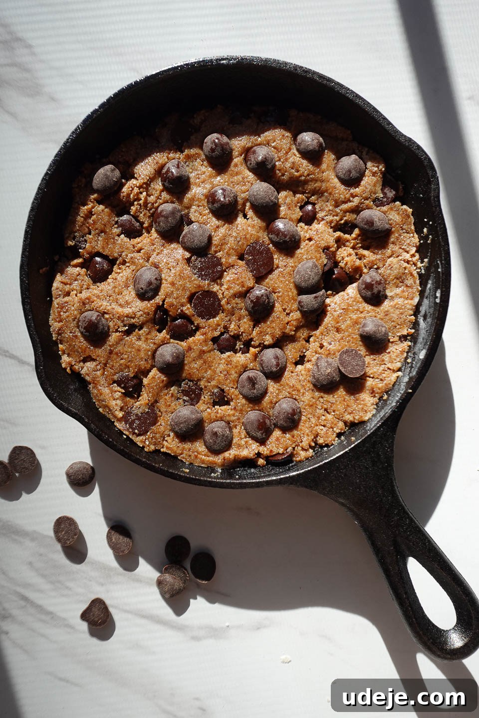 Gooey Skillet Chocolate Chip Cookie Perfection (Vegan and Gluten-Free) 9 Sprinkling extra chocolate chips on top of skillet cookie dough before baking for added indulgence.