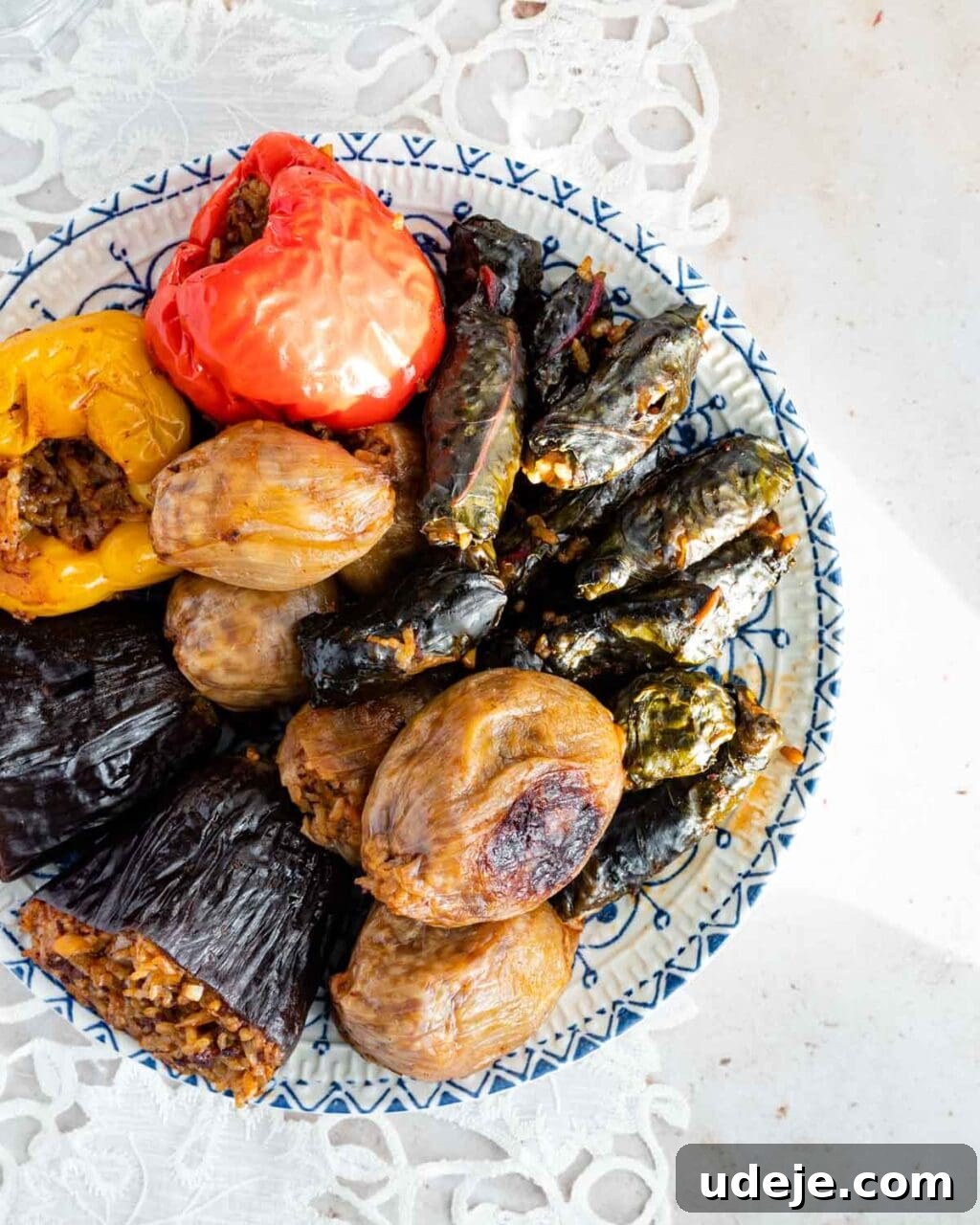 Iraqi Dolma: Stuffed Vegetable Delights 2 Iraqi dolma which is vegetables stuffed with rice and meat is layered onto a patterned blue and white plate