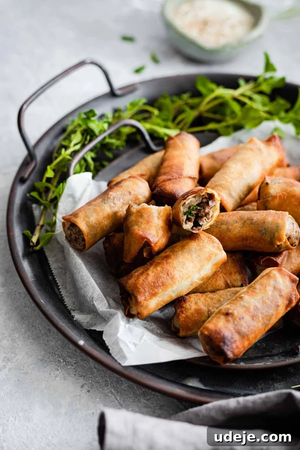 Your Guide to Authentic Homemade Sambousek 24 Sambousak served on a tray garnished with greens
