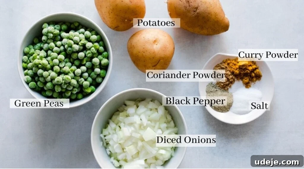 Your Guide to Authentic Homemade Sambousek 4 Overhead view of labeled ingredients for sambousak on a white surface: potatoes, green peas, diced onions, black pepper, salt, curry powder, and coriander powder—perfect for your next sambousak recipe.