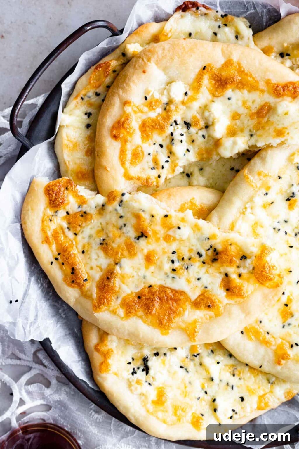 Homemade Cheese and Zaatar Manakish 11 Cheese manakish served on a tray with fresh vegetables