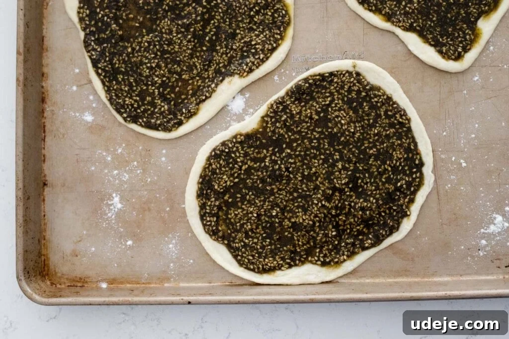Homemade Cheese and Zaatar Manakish 9 za'atar manakish on a baking tray, ready for the oven