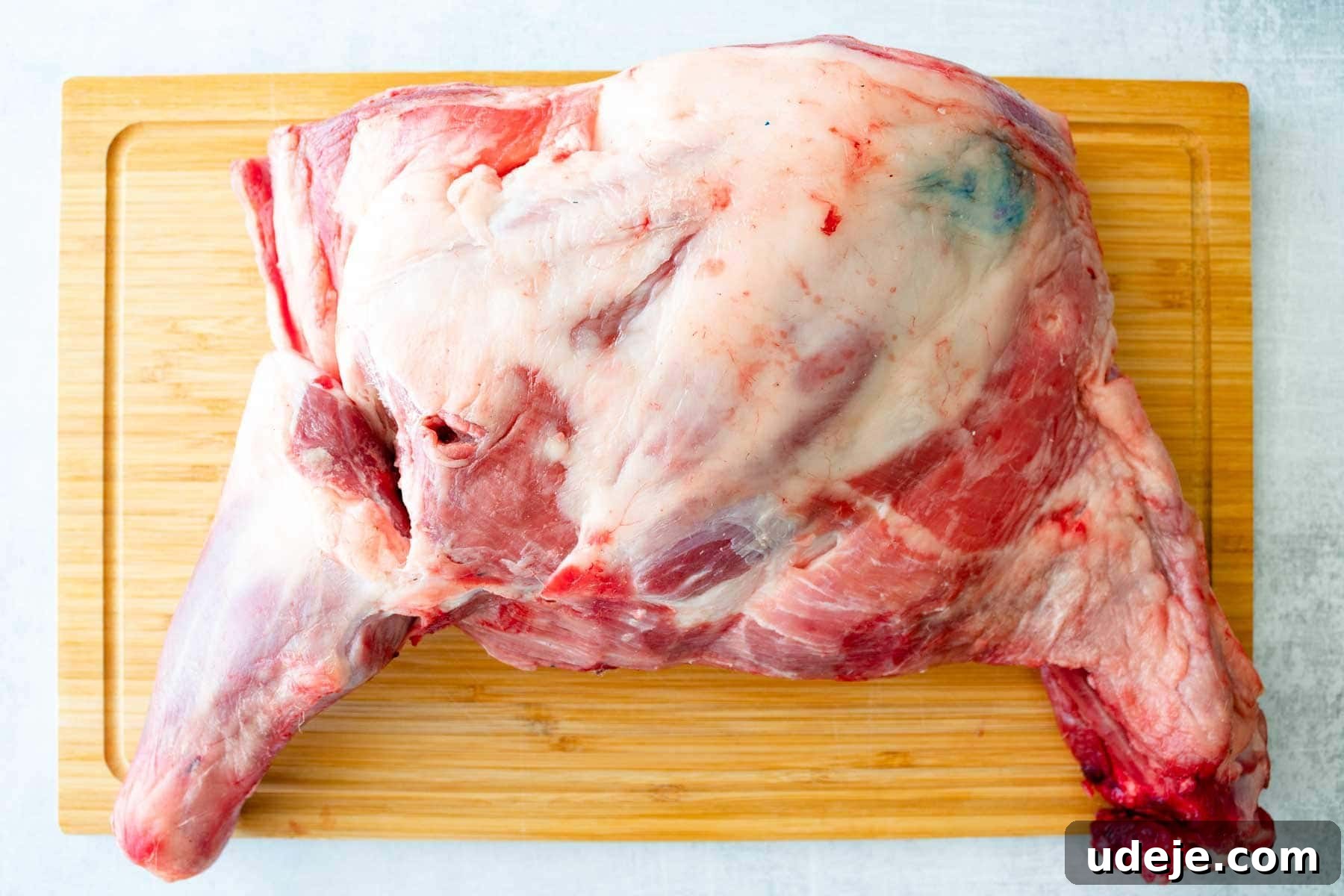 Authentic Iraqi Quzi: Slow-Cooked Lamb on Aromatic Rice 4 raw lamb shoulder being prepared for cooking