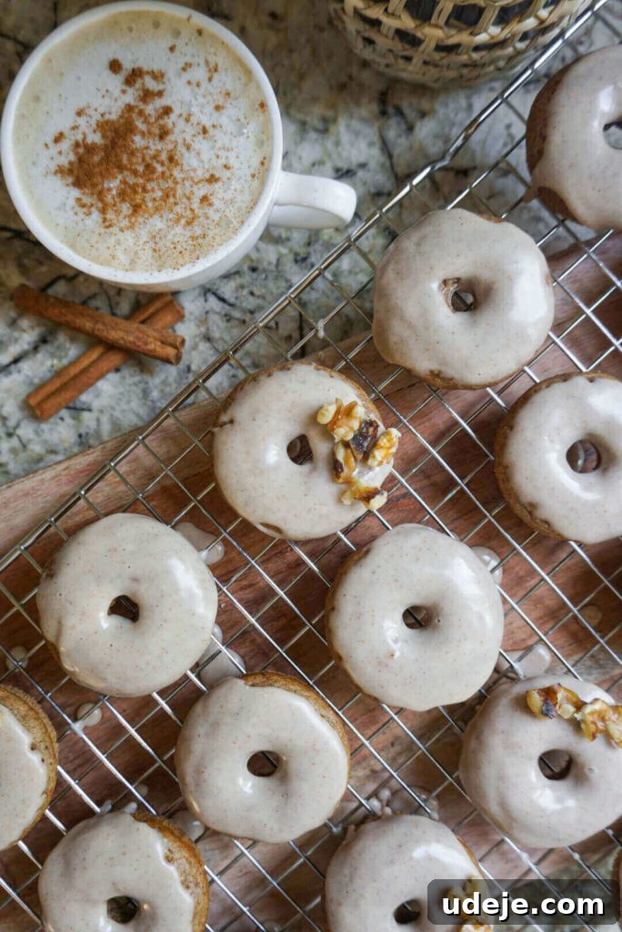 Chai-Spiced Vegan Donuts 2 Delicious Baked Vegan Chai Donuts, perfectly spiced and topped with maple cinnamon icing. A comforting and easy-to-make dessert for autumn.