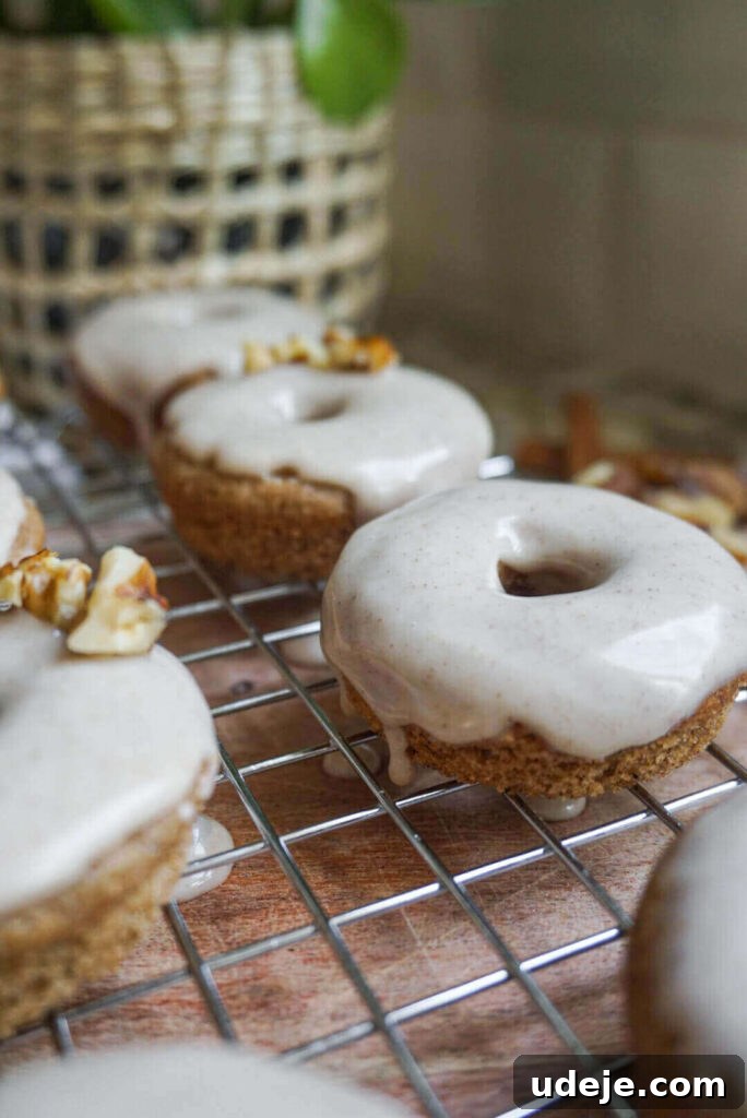 Chai-Spiced Vegan Donuts 3 Close-up shot of a single Vegan Chai Donut, showcasing its soft texture and generous maple cinnamon glaze. Perfect for a cozy morning.