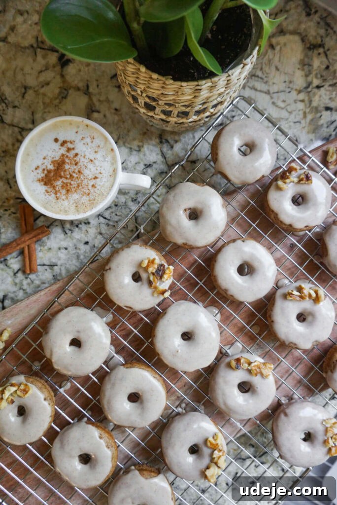 Chai-Spiced Vegan Donuts 6 A stack of freshly iced Vegan Chai Donuts, garnished with a sprinkle of cinnamon, ready to be enjoyed as a comforting fall dessert.