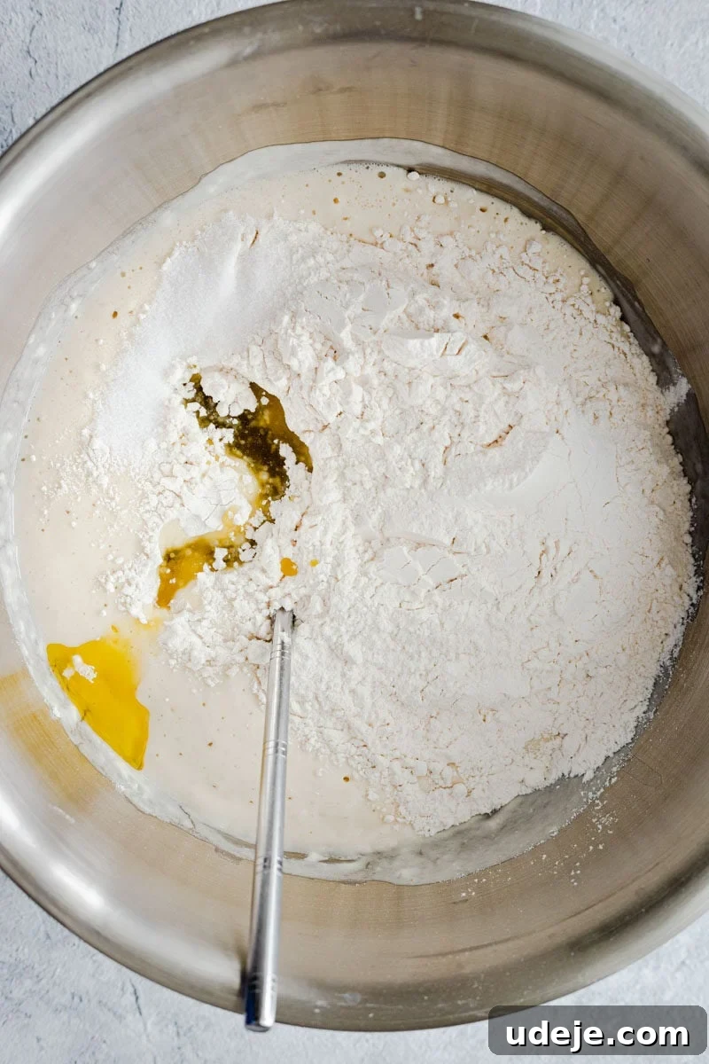 Lahm Bi Ajeen Savory Middle Eastern Flatbread 5 all-purpose flour, water, yeast, salt and sugar in a bowl, ready to be mixed with a spoon