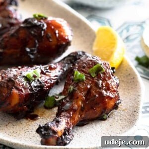 Chicken drumsticks glazed in pomegranate sauce served on a plate