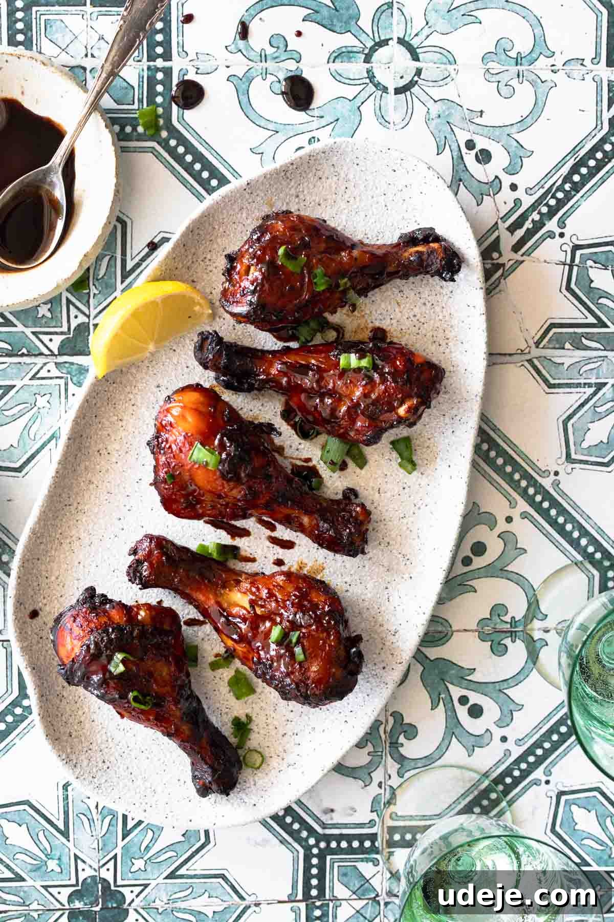Sticky Pomegranate Air Fryer Drumsticks 6 Close-up of golden brown chicken drumsticks glazed in pomegranate sauce served on a white plate