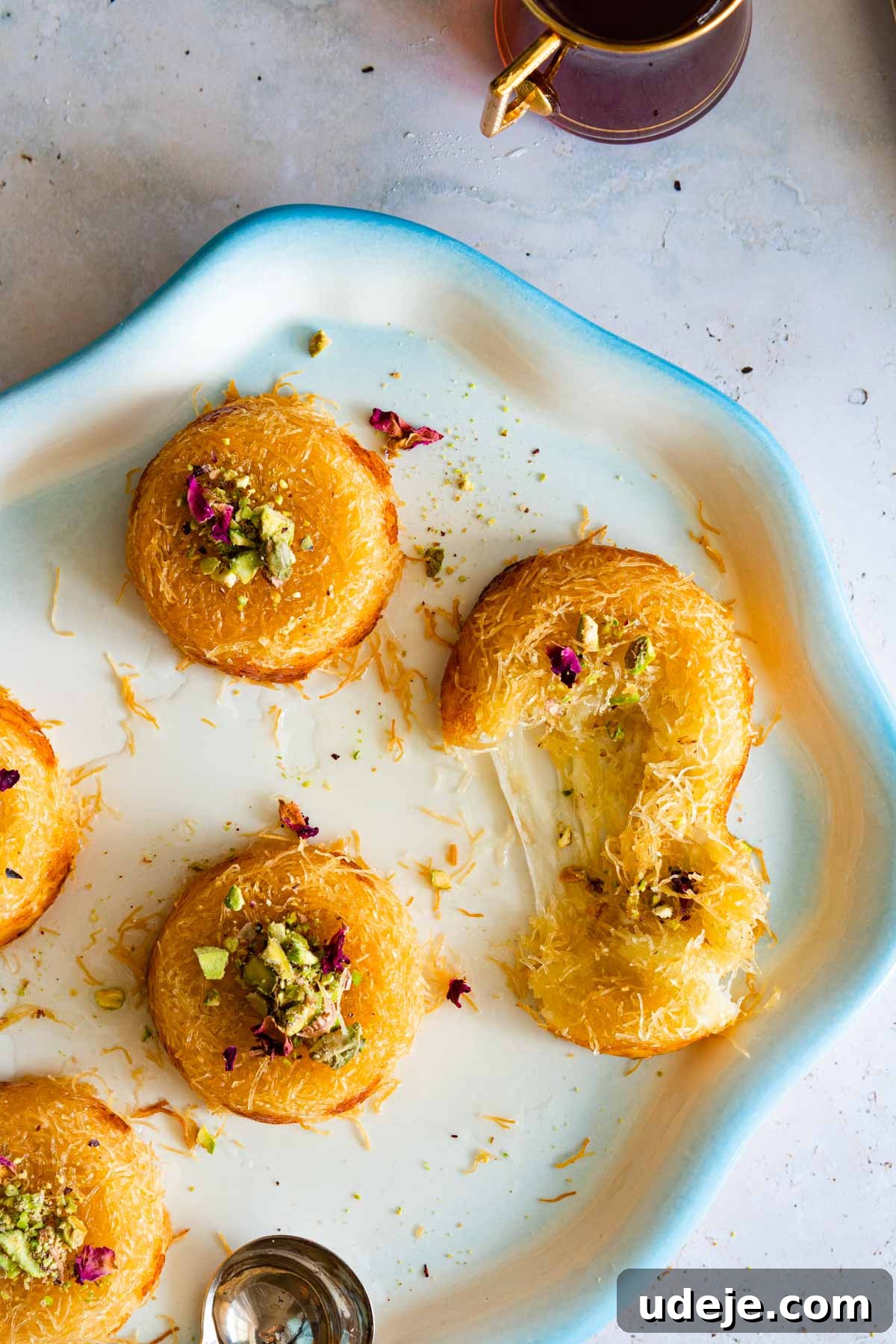 Mozzarella Kunafa Dream Made Simple 11 Mini kunafa cups displayed on a dish garnished with nuts on top.