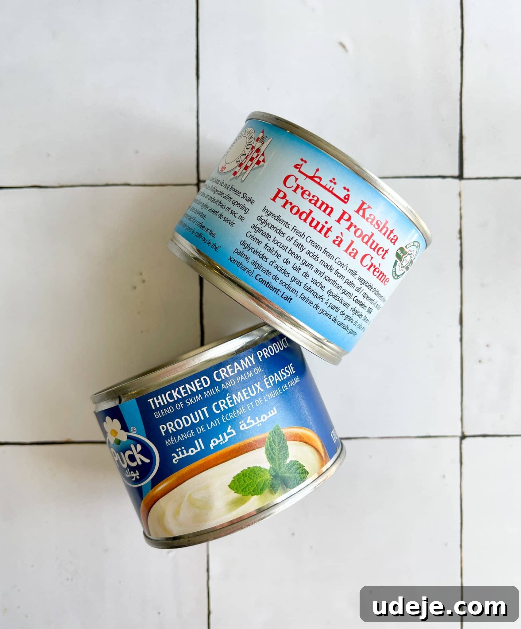 Mozzarella Kunafa Dream Made Simple 6 Two cans of thickened cream on a white tiled background.