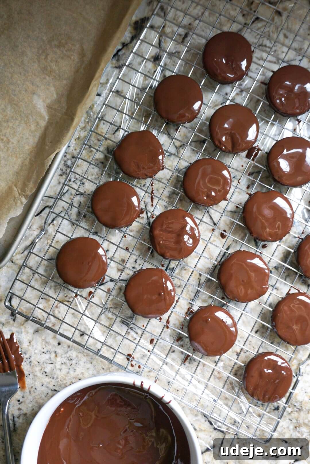 Effortless Vegan Gluten Free Thin Mints 5 Rows of homemade Thin Mints coated in chocolate, resting on parchment paper and waiting for the chocolate to set, showcasing their perfect uniform shape.