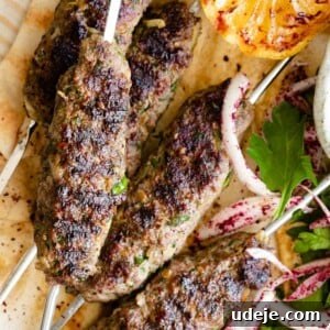 Kafta skewers served on pita bread with onions and parsley