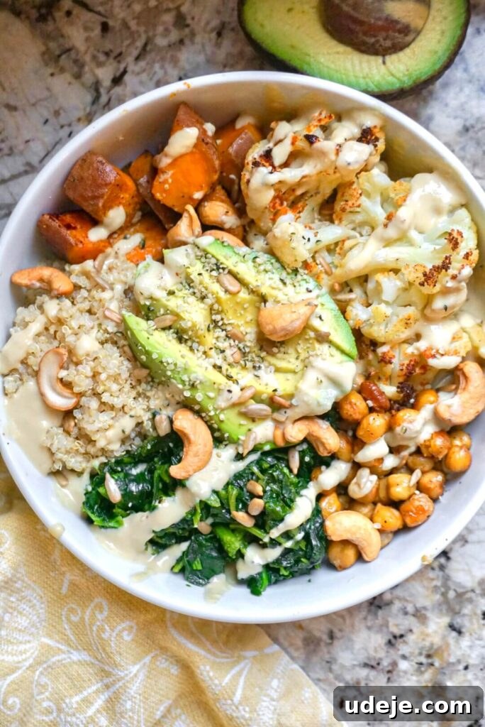 Roasted Sweet Potato, Cauliflower and Chickpea Buddha Bowls 2 A colorful vegan buddha bowl with roasted vegetables, quinoa, and a creamy dressing