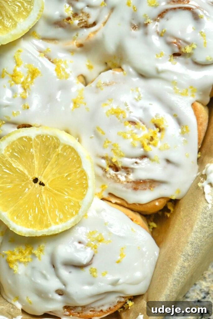 Zesty Vegan Lemon Rolls 3 Close-up of fluffy Vegan Lemon Sweet Rolls with zesty lemon filling, baked golden brown in a square dish.