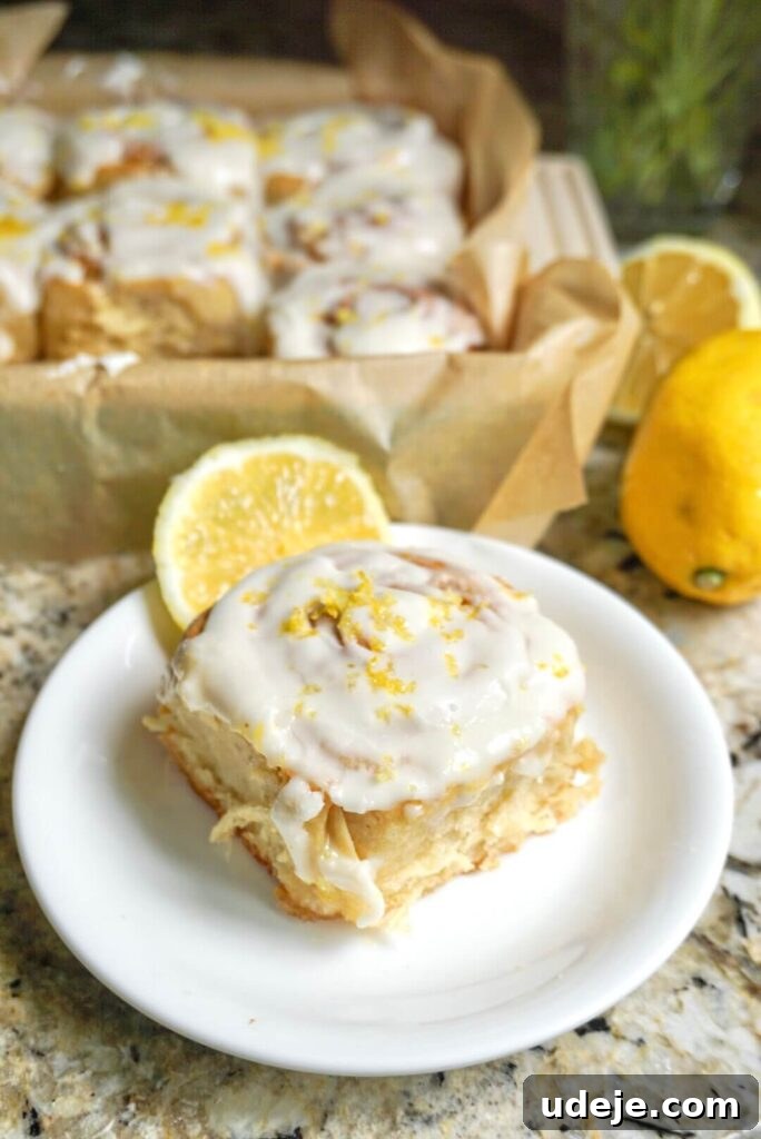 Zesty Vegan Lemon Rolls 8 A beautiful platter of Vegan Lemon Sweet Rolls garnished with fresh lemon zest, capturing their vibrant appeal.