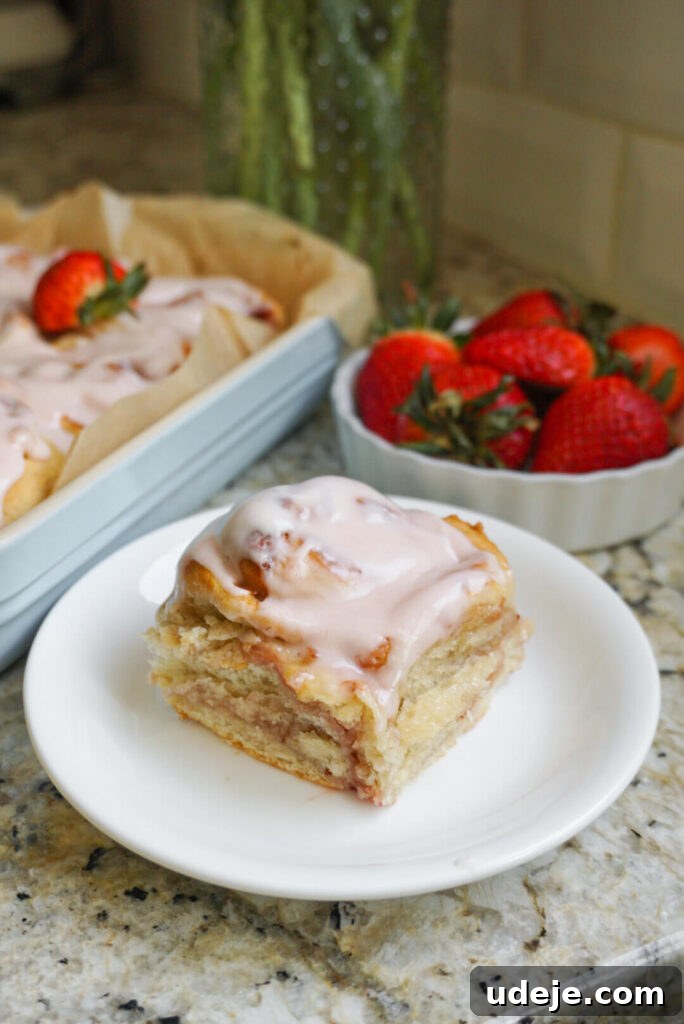 Plant-Based Strawberry Swirls 3 Close-up of fluffy Vegan Strawberry Rolls, beautifully baked and ready for icing, promising a delightful treat.