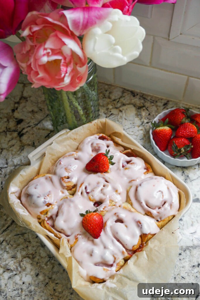 Plant-Based Strawberry Swirls 4 Freshly baked Vegan Strawberry Rolls showcasing the vibrant strawberry swirl and inviting texture.