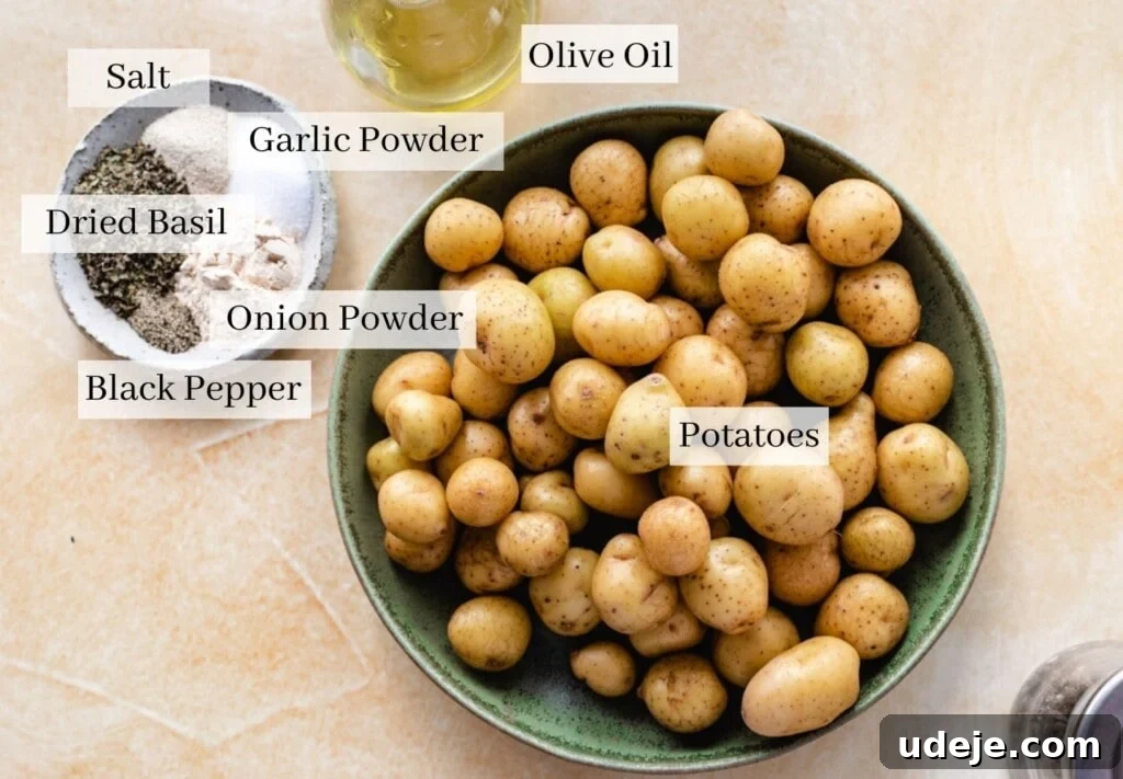 Perfectly Crispy Roasted Potatoes 3 A collection of fresh ingredients for roasted potatoes, including whole potatoes, a bottle of olive oil, and small bowls of dried basil, garlic powder, and onion powder.