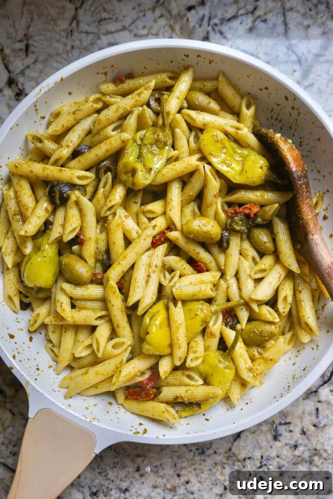 Vibrant Mediterranean Pesto Feast 3 Indulge in the delicious flavors of the Mediterranean with this spicy penne pasta dish featuring pesto, olives, sun-dried tomatoes and pepperoncini.