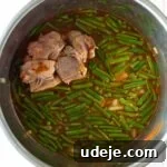 Effortless Green Bean Stew Instant Pot and Stovetop 18 Green bean stew in the instant pot on a light tiled background
