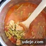 Effortless Green Bean Stew Instant Pot and Stovetop 19 green bean stew with veal cooked in the instant pot with a wooden spoon