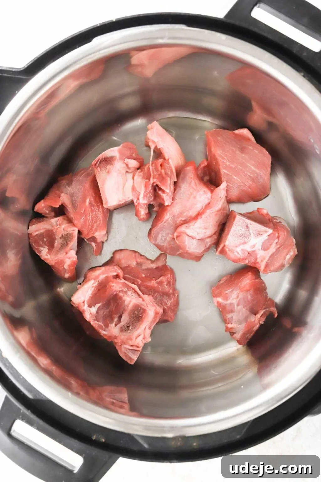 Effortless Green Bean Stew Instant Pot and Stovetop 6 veal cubes browning in hot olive oil in an Instant Pot